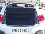 a white car with its trunk open on the street