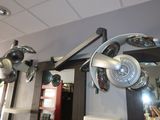 many lights hanging from the ceiling of a hair salon