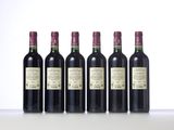 six bottles of wine are lined up on a table