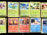 several pokemon cards sitting on top of each other on a table