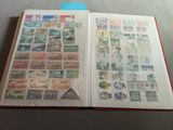 an open book with stamps on it sitting on a table