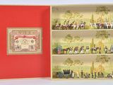 a red box with miniature figurines of people in it
