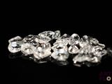 several pieces of clear diamonds on a black surface