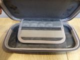 a person holding a case that has a wallet inside of it