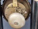 a close up of a clock that is on a pole