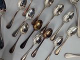 a lot of silver spoons and spoon spoons on a table