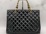 a chanel black quilted leather handbag with gold chain handles