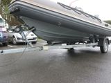 a boat on a trailer being towed by a truck