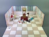 a small model of a room with a table and chairs