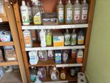 many bottles of cleaning products on the shelves in the bathroom
