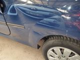 a blue car that is parked in a garage