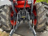 a tractor that is parked on the side of the road