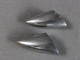 two silver cones on a table with a gray background