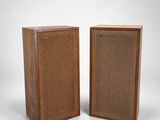 a pair of speakers with a wooden case and wicker covering