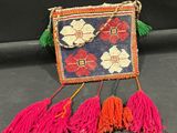 une image représentant un sac à main dont pendent des pompons