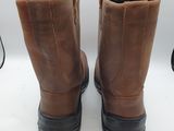 the back of a pair of brown boots on a white surface