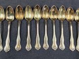 six spoons are lined up in a row on a table
