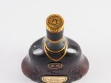 an image of a bottle of liquor sitting on a white surface