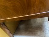 a wooden table with a drawer underneath it on the floor