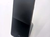 a cell phone that is sitting on top of a stand