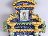 a blue and yellow wall clock with a picture on it
