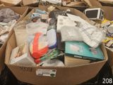 a box full of electronics and other items sitting on the floor
