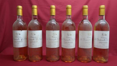 six bottles of wine are lined up in a row on a red background