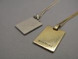 two pieces of metal are shown on a table with a chain