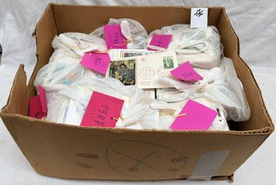 a cardboard box filled with lots of items that have been wrapped in plastic