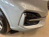 a close up of the front end of a silver car