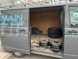 a van that has some tires in the back of it