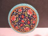 a blue plate with a floral design on it