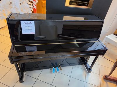 a piano that is sitting on the floor in the room