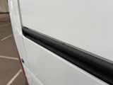 a white van parked in a parking lot next to a building