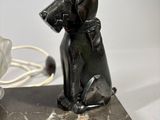 a close up of a statue of a dog on a marble base