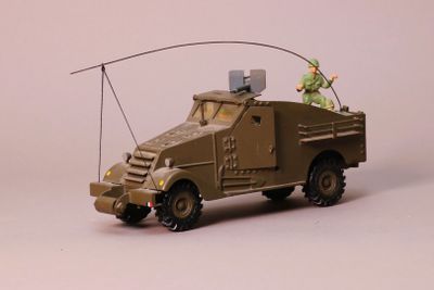 a toy army truck with a man on top of it