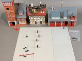 a small model of a building with a lot of people on it
