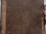 someone is holding a piece of wood with a sticker on it