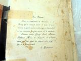 an old book with writing on it sitting on a table