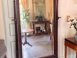 a large mirror sitting on a table in a room