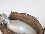 someone is holding a metal bottle in a brown leather case
