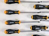 many different types of screwdrivers lined up on a table