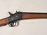 an old gun is laying on a table with a white background