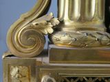 a gold clock that is sitting on top of a table