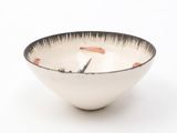 a black and white bowl on a white surface
