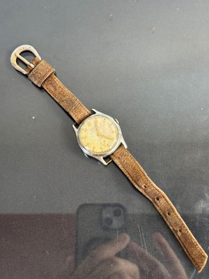 someone is taking a picture of a watch with their cell phone