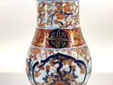 a vase that is sitting on a white surface