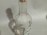 a glass bottle with a cork stopper on top of it