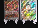 two pokemon trading cards on display on a black background