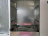 a metal cabinet with a bunch of mushrooms inside of it